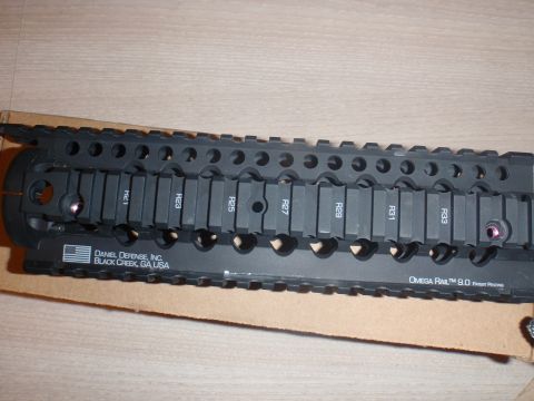 2000 Dodge 1500 - Close-up of a Daniel Defense Omega Rail 9.0 accessory rail, marked with R numbers.