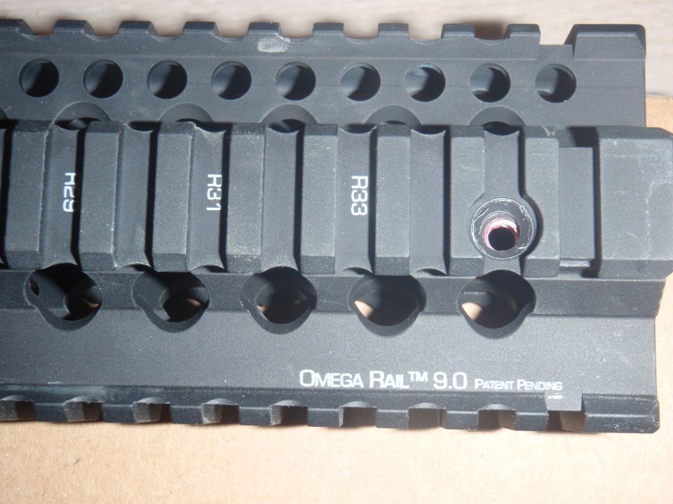 Close-up of an Omega Rail 9.0 accessory with markings H29, H31, and R33