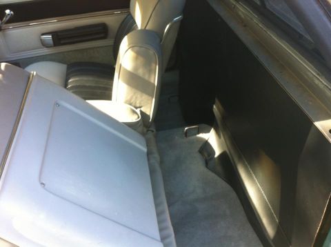 1979 Ford Ranchero - The interior of a vehicle is shown, focusing on the rear seating area and carpet.