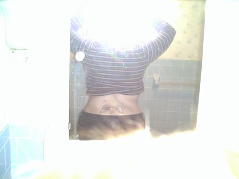 1994 Ford Crown Victoria - A tattoo is visible on the lower back of a person reflected in a mirror.