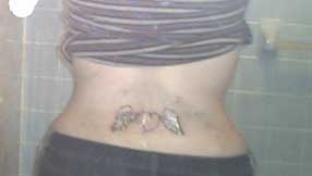 1994 Ford Crown Victoria - A tattoo is visible on the lower back of a person.