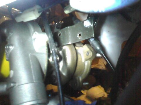 2003 Ford Crown Victoria - A close-up view of a vehicle's brake caliper assembly and associated components.