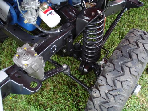 1994 Ford F-350 - Close-up view of vehicle suspension and steering components, including a tire and a filter with text.
