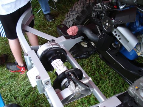 1994 Ford F-350 - Close-up of a vehicle chassis part, possibly a winch assembly, with a handwritten note attached.