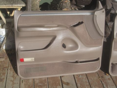 1993 Ford Bronco - Tan Ford Bronco door panel for sale, shows speaker grille and red reflector.