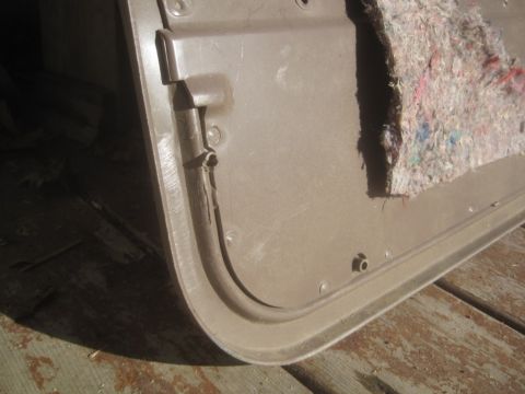 1993 Ford Bronco - This is a close-up view of a vehicle's interior door panel, showing the raw insulation material.
