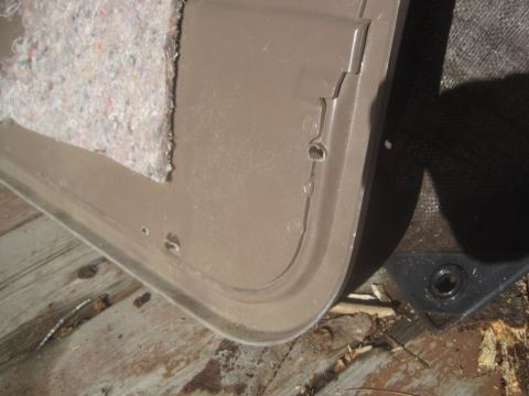 1993 Ford Bronco - Close-up of a car door panel interior with visible insulation and screw holes.