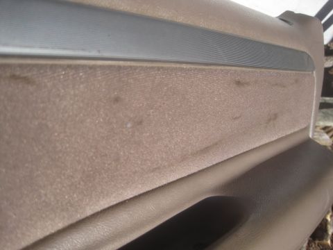 1993 Ford Bronco - This is a close-up view of a vehicle's interior door panel, showing the fabric insert and trim.