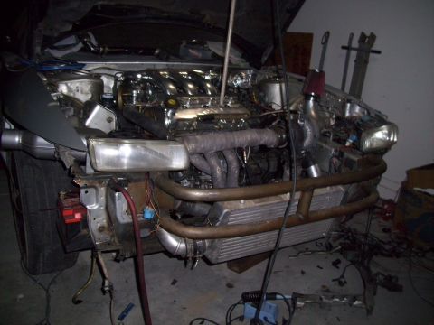 1995 Ford Probe - Customized engine bay shows turbocharger and intercooler, front end is disassembled.