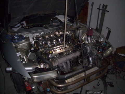 1995 Ford Probe - The engine bay shows a heavily modified engine with a turbocharger and custom exhaust components.