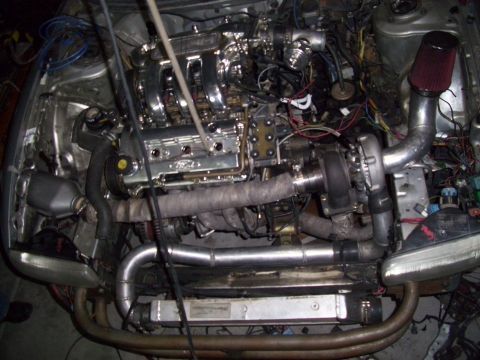 1995 Ford Probe - The engine bay shows a turbocharger and custom piping, with 'Ford' visible on the intake manifold.