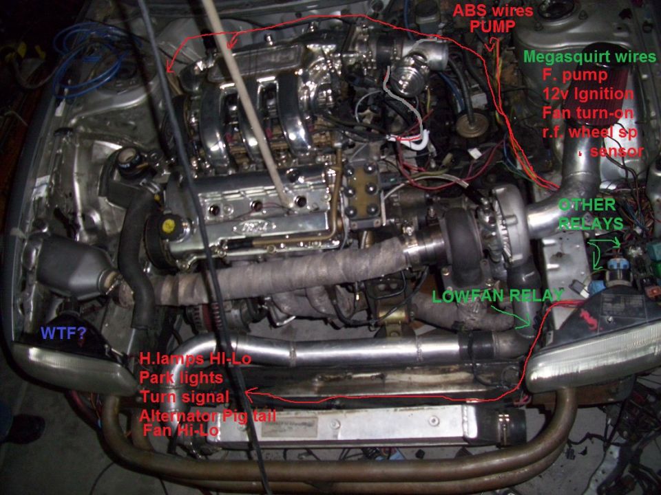 Engine bay with turbocharger and labeled wiring. View shows custom modifications