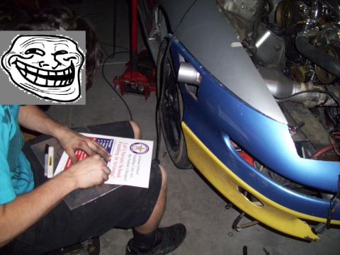 1995 Ford Probe - Car front end with engine bay visible, being worked on by a person holding a document.