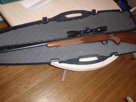 2000 Dodge 1500 - A rifle with a scope is placed inside its open protective case.