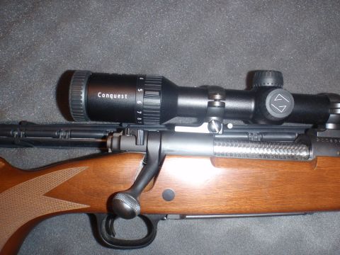 2000 Dodge 1500 - Close-up view of a rifle scope and its mounting hardware on a firearm.