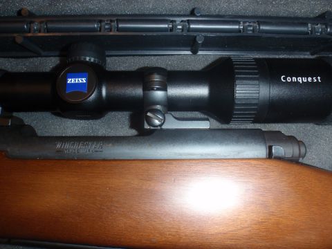 2000 Dodge 1500 - Close-up of a Winchester rifle's scope and wooden stock.