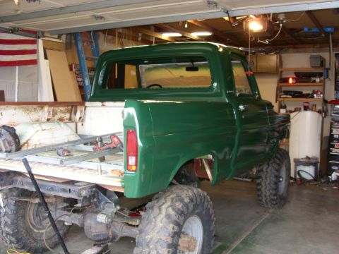1967 Ford F-250 - This 1967 Ford F-250 pickup truck, modified with large tires, is seen in a garage undergoing work.