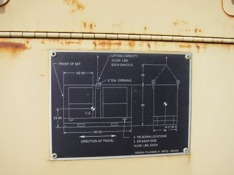 1991 Ford LTD Crown Victoria - Riveted equipment data plate listing lifting capacity, tie-down locations and dimensioned shipping outline for a generator set.