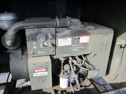 1991 Ford LTD Crown Victoria - This military generator engine features various gauges and warning labels, including 'Danger High Voltage'.