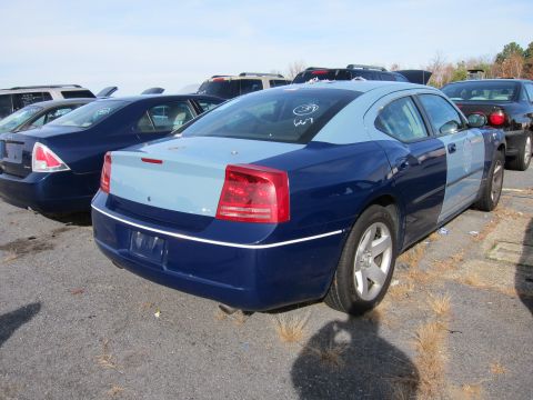 1991 Ford LTD Crown Victoria - A two-tone Dodge Charger is parked in a vehicle lot alongside other cars.