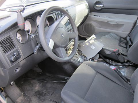1991 Ford LTD Crown Victoria - The interior of a car shows significant damage to the dashboard and center console area.