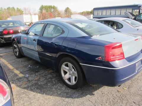 1991 Ford LTD Crown Victoria - This two-tone blue sedan is seen from the rear quarter angle, with a visible number on the driver's side window.
