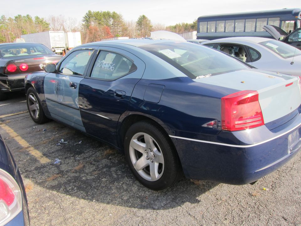 Two-tone blue sedan rear quarter view. Number 708856 on window