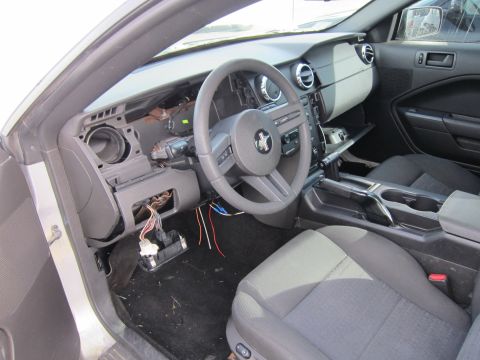 1991 Ford LTD Crown Victoria - The interior of a Ford Mustang shows a disassembled dashboard with exposed wiring and a steering wheel.