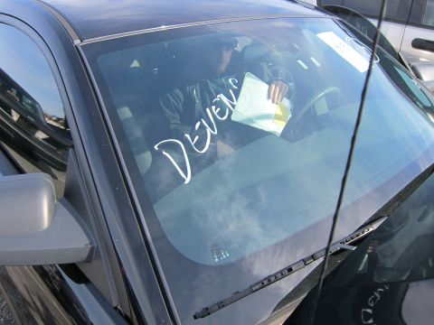 1991 Ford LTD Crown Victoria - White text 'DEVENS' is written on the windshield of a car's interior.