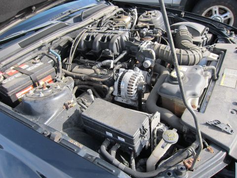 1991 Ford LTD Crown Victoria - The engine bay of a vehicle is shown with various components and wiring.