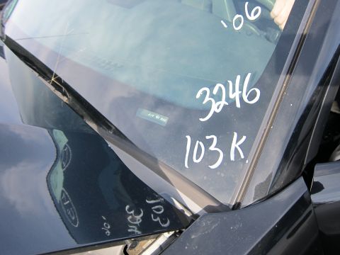 1991 Ford LTD Crown Victoria - Handwritten markings on a car's windshield and hood obscure any definitive year or model identification.
