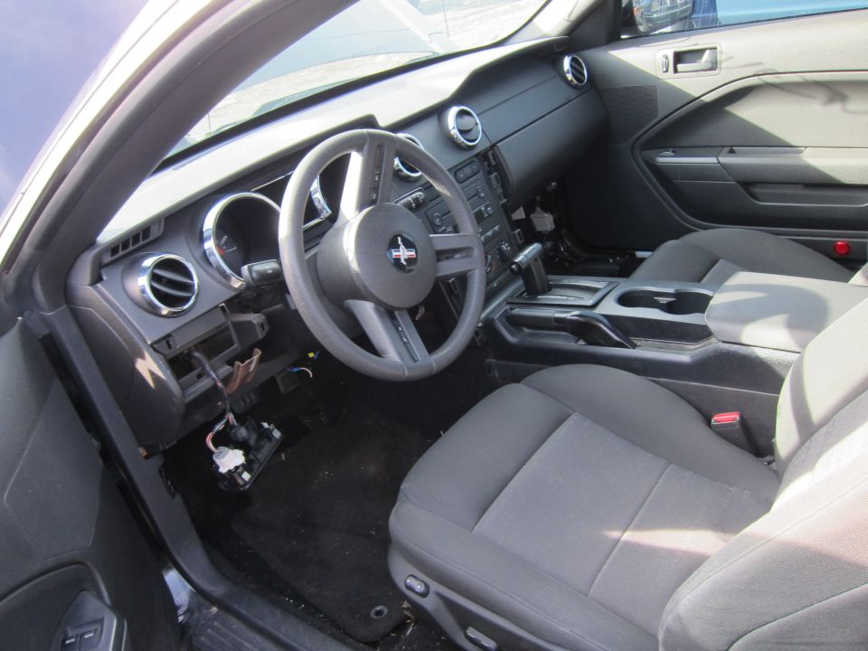 Interior view of a car with gray seats and a black dashboard