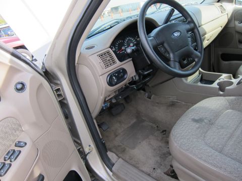 1991 Ford LTD Crown Victoria - The interior of a 2001 Ford Explorer, the dashboard, steering wheel, and passenger seat.