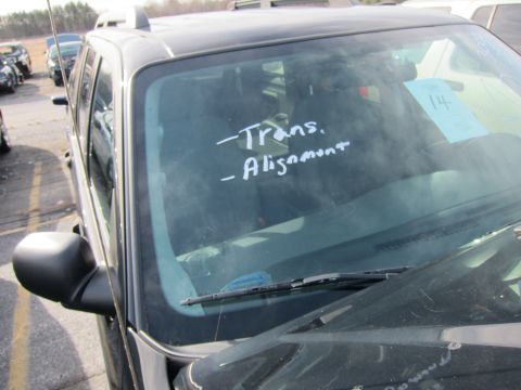 1991 Ford LTD Crown Victoria - Handwritten notes on a vehicle's windshield indicate service needs like transmission and alignment.