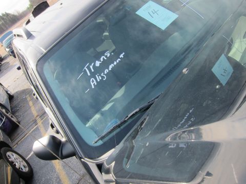 1991 Ford LTD Crown Victoria - Handwritten notes on a car's windshield indicate service needs for transmission and alignment.