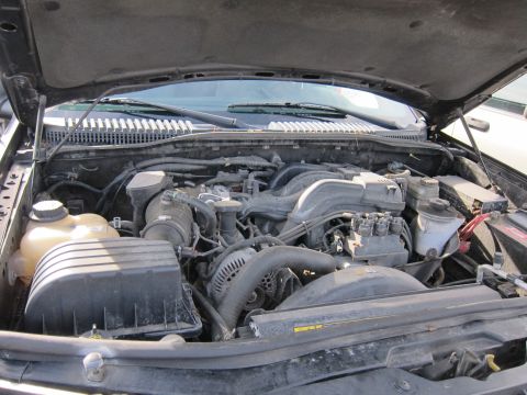 1991 Ford LTD Crown Victoria - The engine bay of a vehicle is shown with various components and wiring.