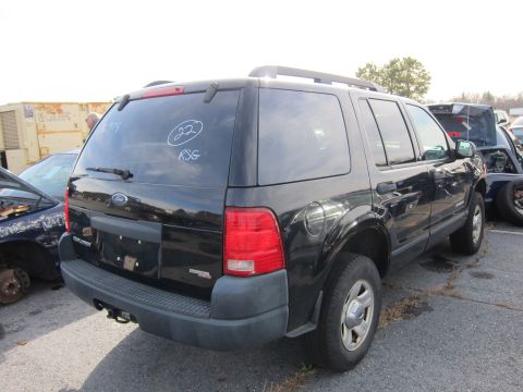 1991 Ford LTD Crown Victoria - Rear view of a black Ford Explorer with '22' and 'RSG' written on the rear window. Another vehicle is visible to the left.