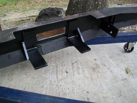 1982 Ford F-100 - A heavy-duty custom bumper with multiple welded brackets sits on a concrete surface.