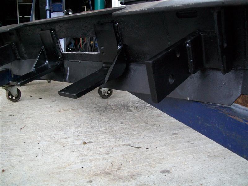 Black metal bumper fabrication with caster wheels attached to the frame