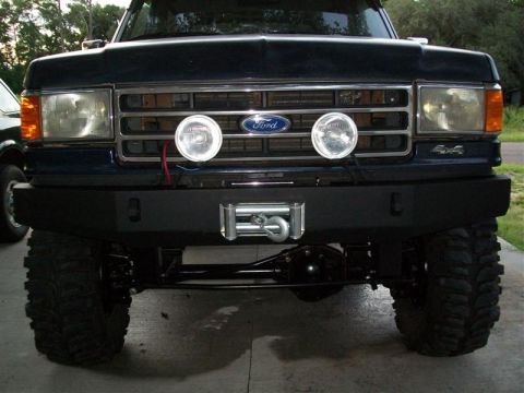 1982 Ford F-100 - This Ford F-Series truck features a custom winch bumper and auxiliary lights mounted on the grille.