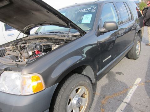 1991 Ford LTD Crown Victoria - A black Ford Explorer SUV is shown with its hood open, revealing the engine compartment.