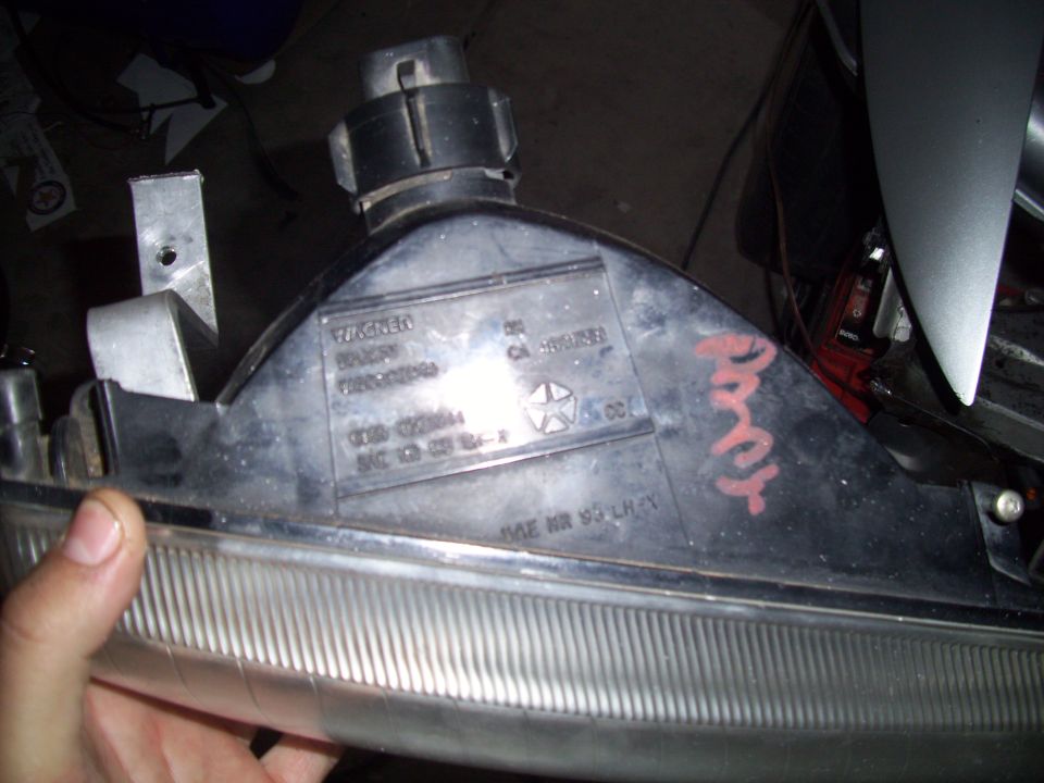 Close-up of a car headlight assembly with 'WAGNER' and part numbers visible