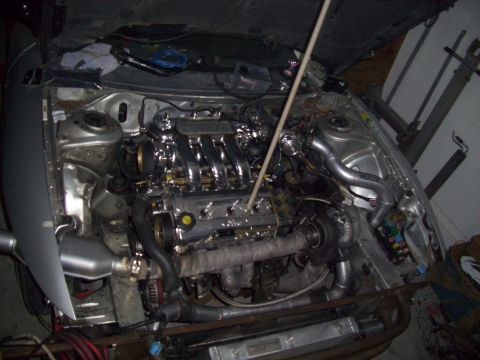 1995 Ford Probe - The engine bay shows a custom turbo setup with polished intake runners and exhaust manifold wrapping.