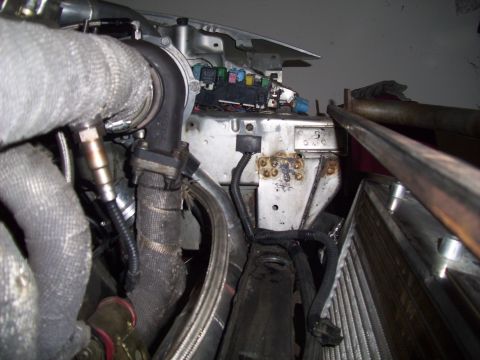 1995 Ford Probe - Close-up view of engine bay components, including a turbocharger and fuse box, with visible signs of wear and tear.