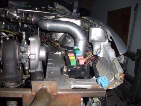 1995 Ford Probe - Custom engine bay modifications a turbocharger and associated plumbing, along with a visible fuse box.
