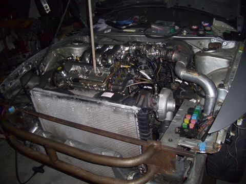 1995 Ford Probe - The engine bay shows a modified setup with a prominent turbocharger and intercooler system.