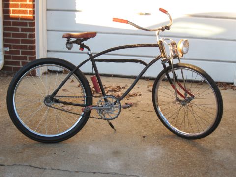 1994 Ford Bronco - Custom cruiser bicycle with a vintage look, parked outdoors near a garage.