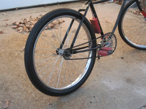1994 Ford Bronco - A close-up view shows the rear wheel and drivetrain of a bicycle, with a red canister attached to the frame.