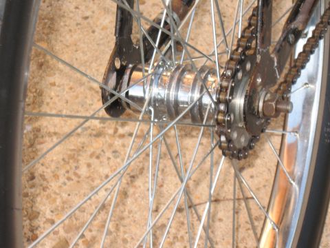 1994 Ford Bronco - Close-up view of a bicycle's rear wheel assembly, showing the hub, spokes, and drive chain.