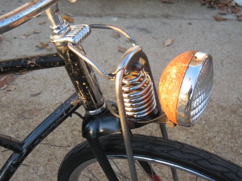 1994 Ford Bronco - Front view of a vintage bicycle's rusty headlight and suspension system.